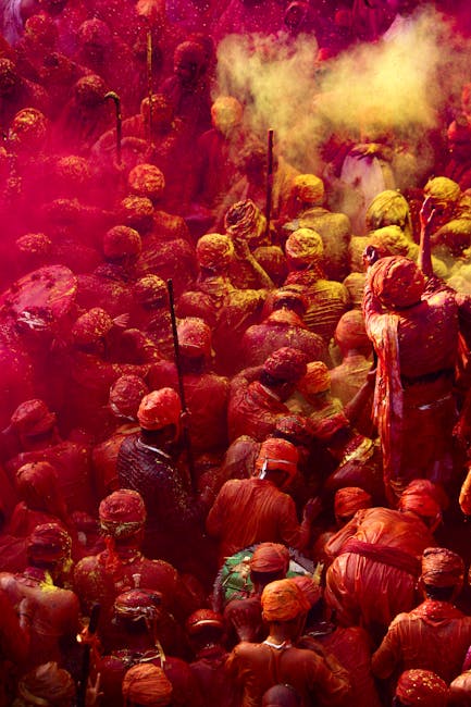 Crowd celebrating Holi with colorful powder in the air