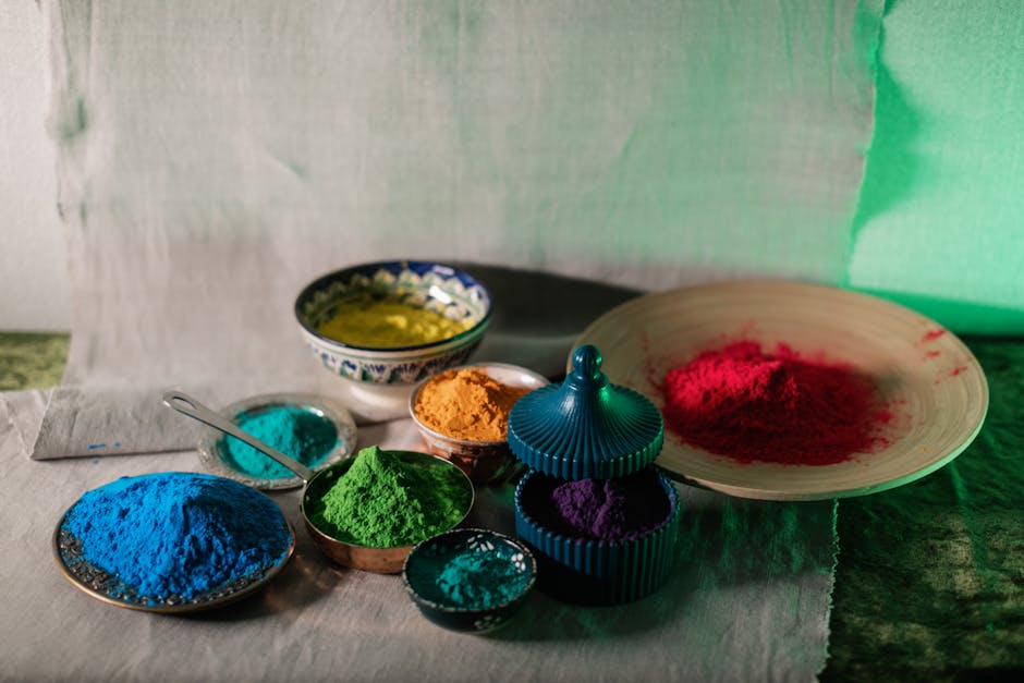 Bowls of colorful Holi powders arranged in bright hues